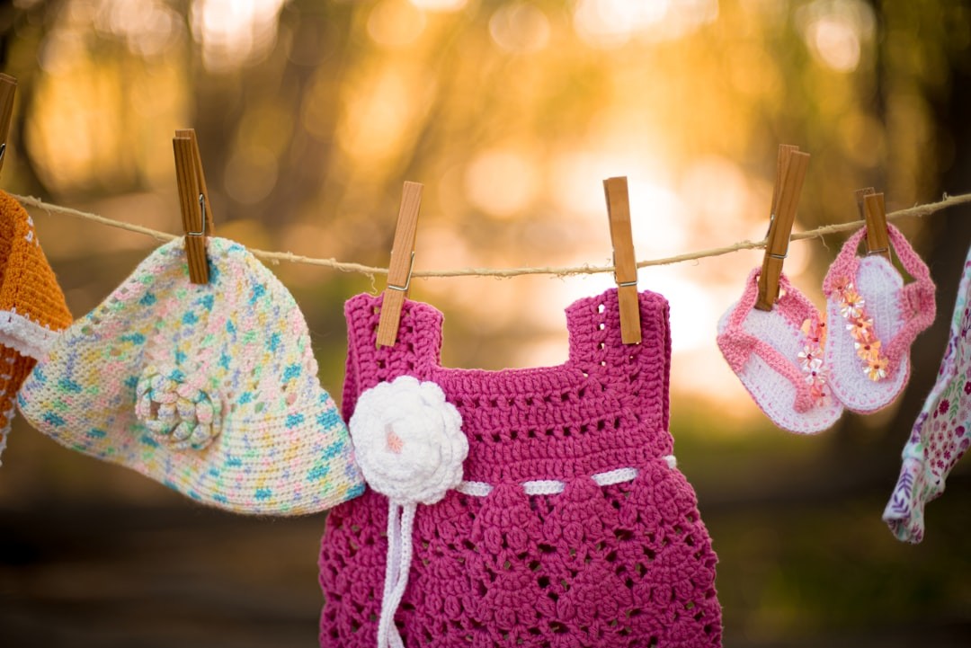 a line of crocheted clothes hanging on a clothes line